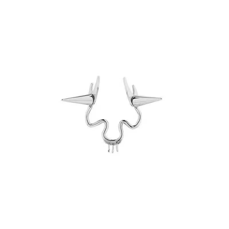 Studio product image of a curved metallic double nose cuff with two side spikes and hanging detail