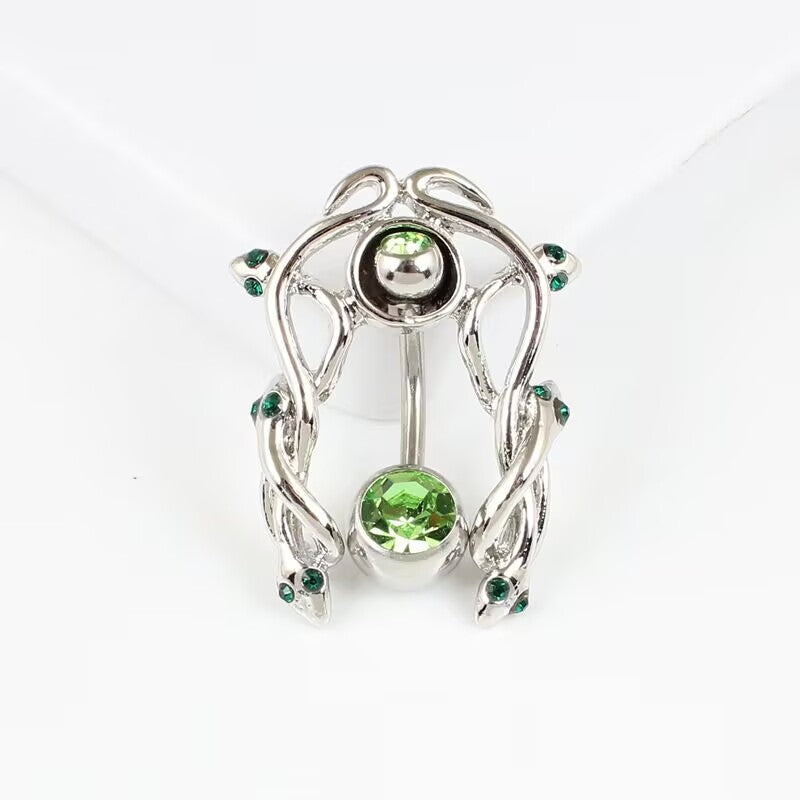 Studio product shot of the gothic emerald green CZ snake navel piercing shield assembled on a clean white background.