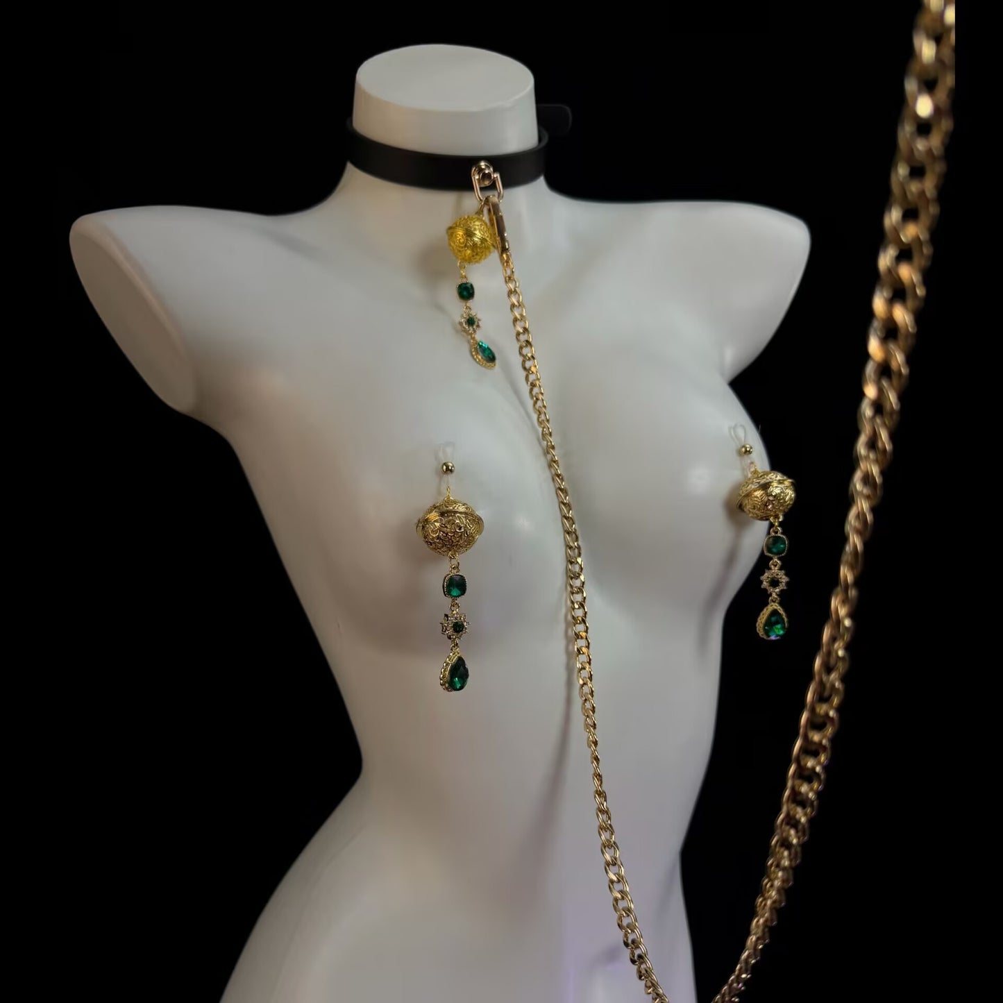 Gothic style emerald non-pierced nipple clamps connected to black leather choker collar with a gold detachable chain leash.