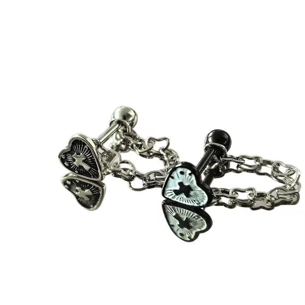 Side-by-side view of black and antique silver gothic heart cross tongue barbells with heart dangle chains.