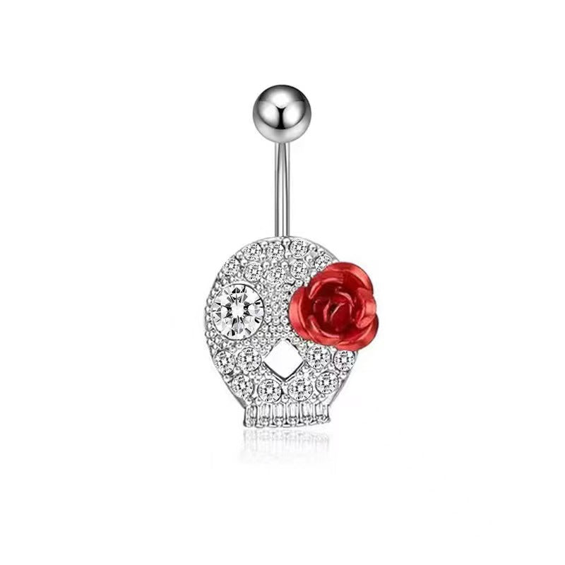 Sparkling crystal skull navel ring with a vibrant red rose detail on a white background.