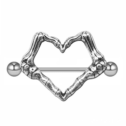 A silver-toned heart-shaped nipple shield featuring two skeleton hands joined together with a straight barbell piercing.