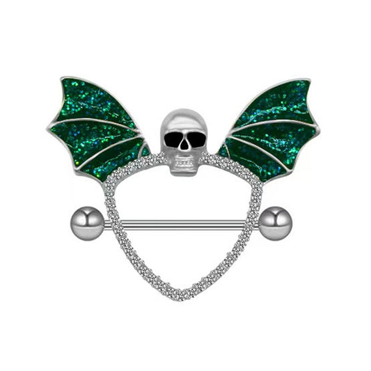 Front view of a gothic nipple shield featuring a silver skull and green glitter bat wings.
