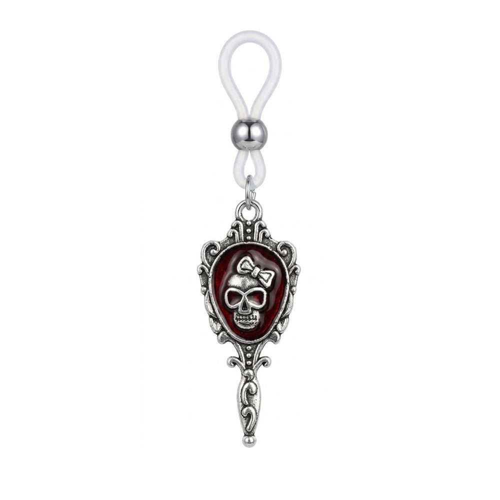 A single silver gothic nipple ring featuring a skull with a bow inside a vintage mirror frame with an adjustable silicone loop.