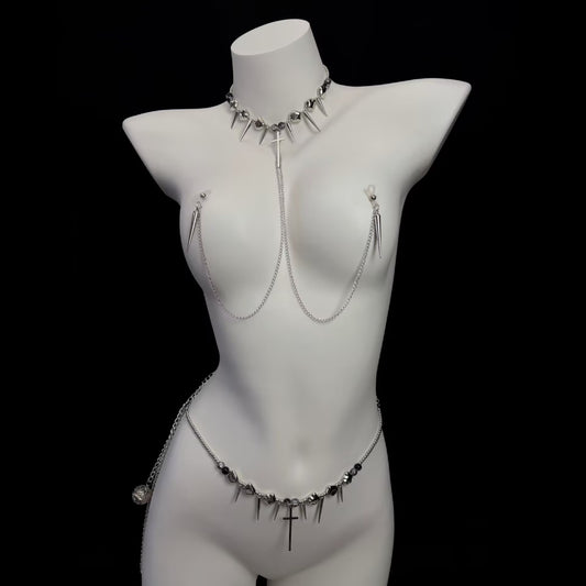 Full front view of a gothic spike choker and cross nipple chain harness set with matching spike waist chain on a mannequin.