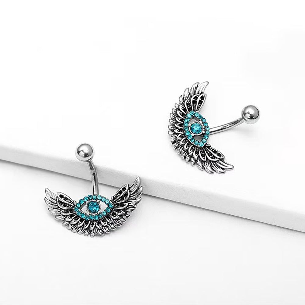 Two gothic style evil eye belly rings displayed on a white surface showing 3D details.