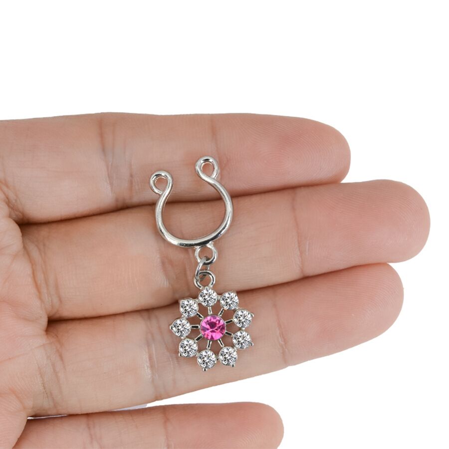 A non-piercing flower nipple ring held in a hand to provide a real-life size reference.