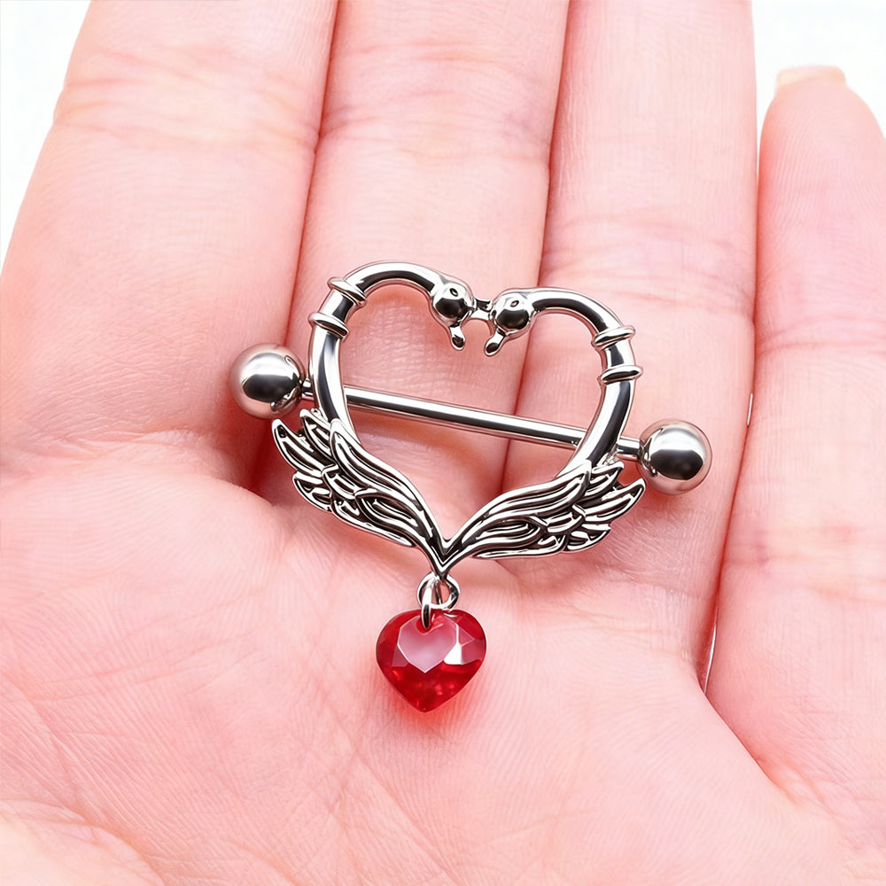 A hand holding the swan heart nipple shield to show the actual product scale.