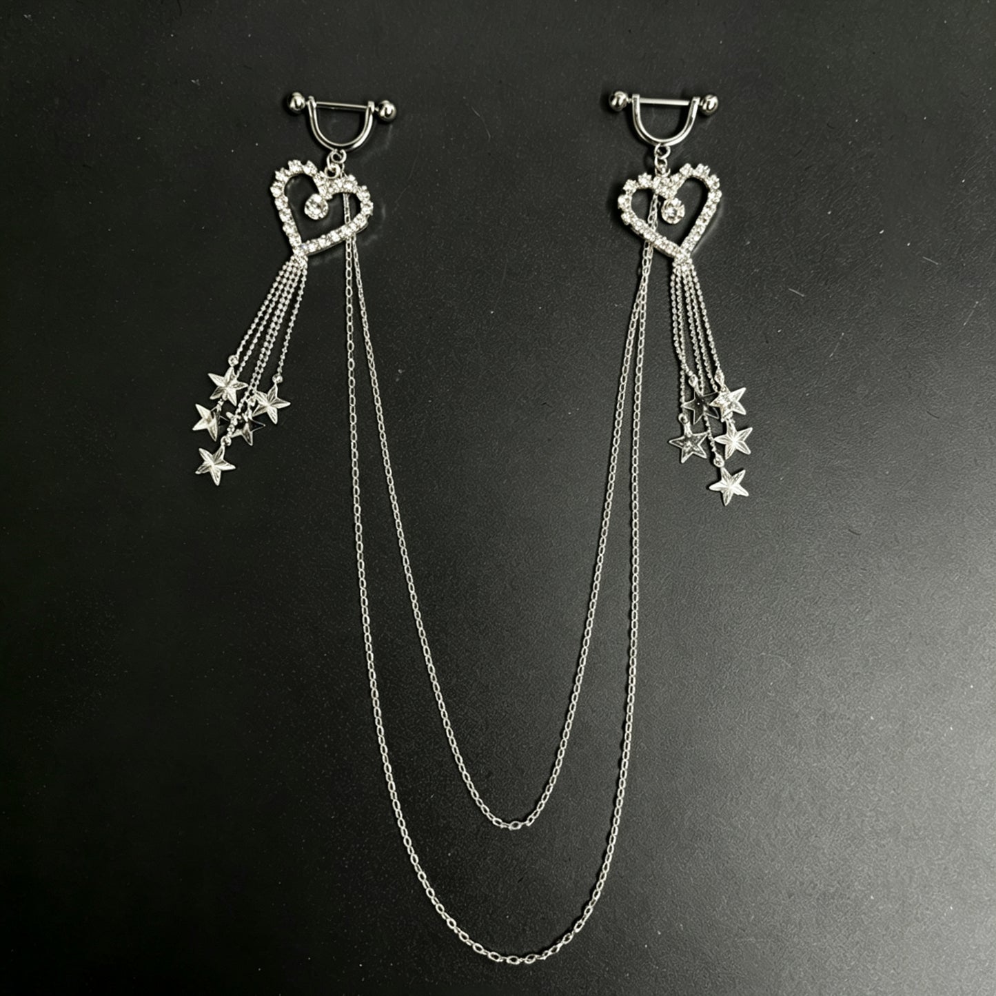 Sparkling silver heart nipple piercing jewelry set with dangling star charms and multi-layer connecting chest chain.