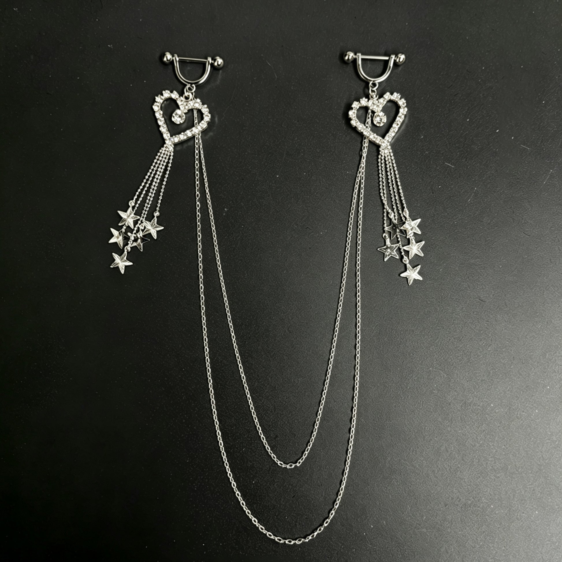 Sparkling silver heart nipple piercing jewelry set with dangling star charms and multi-layer connecting chest chain.