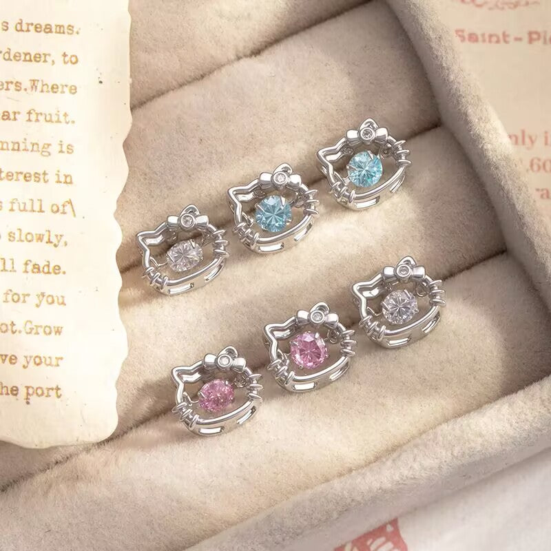 Multiple color variations of hello kitty style flat back cartilage studs featuring floating cz crystals in jewelry tray