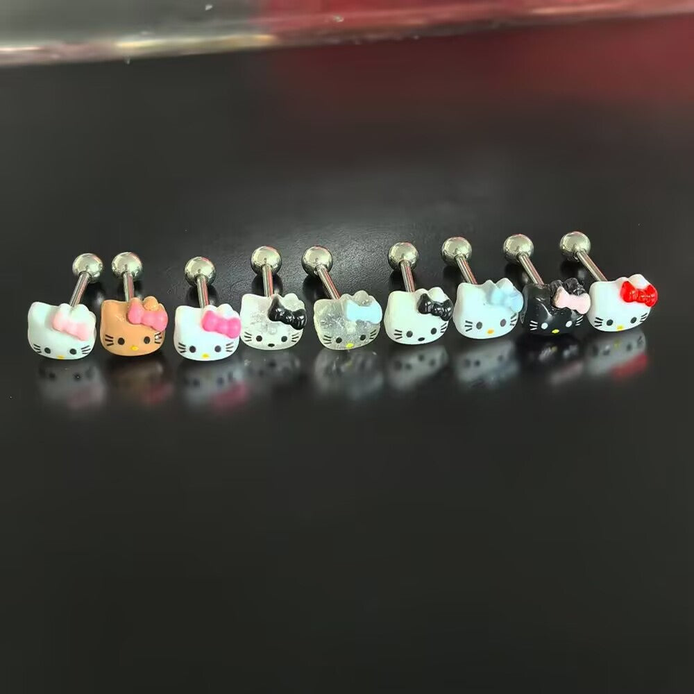 Collection of multi-colored cute kitty tongue rings in pink red blue black and glitter options lined up in a row.