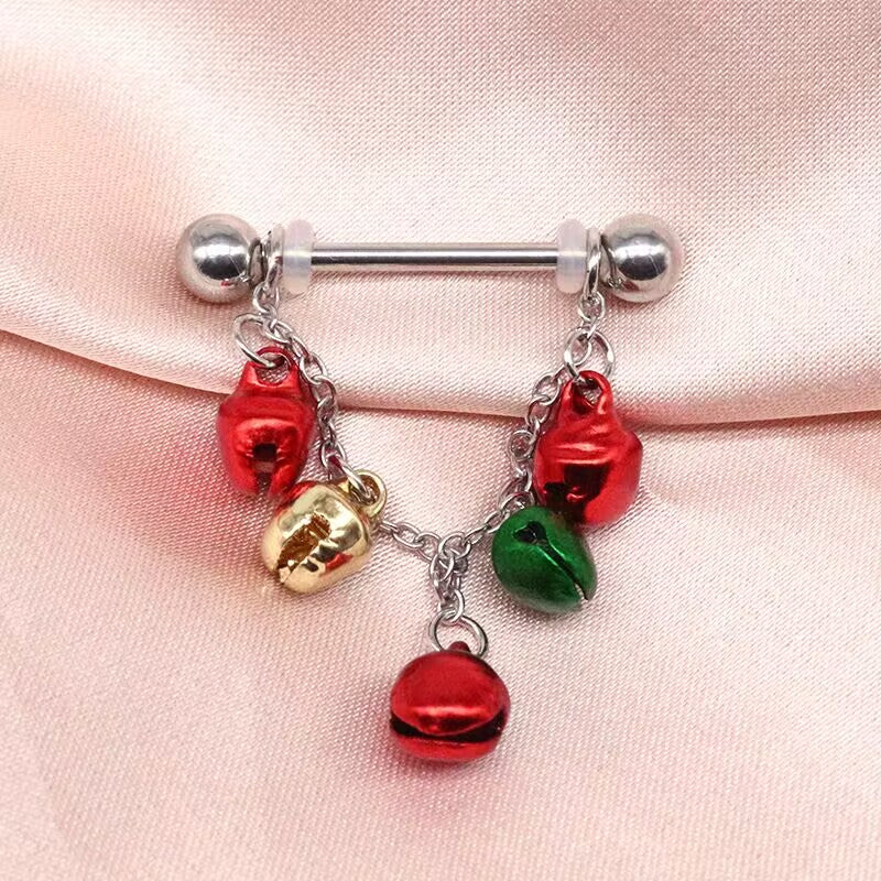 Holiday bell nipple piercing jewelry with silicone o-rings on smooth pink satin background