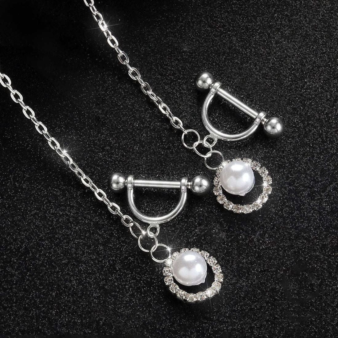 Close-up view of the straight barbell piercing portions of the non-adjustable body chain, featuring elegant silver horseshoe-shaped drapes with micro-pave rhinestone rings and white pearls.
