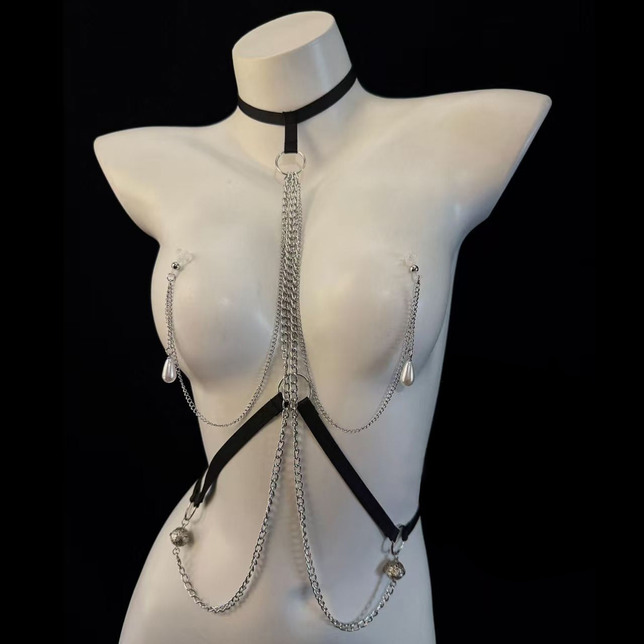 Gothic chest chain harness styled with stainless steel pierced nipple barbell jewelry and dangling pearl drops.