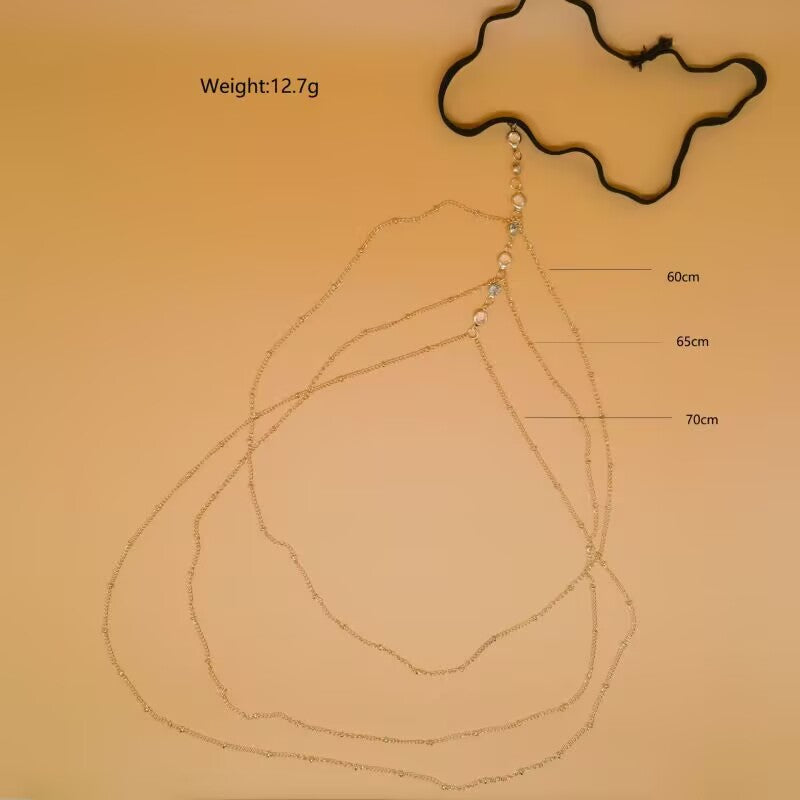 Product dimensions and weight display for gold layered rhinestone thigh chain body jewelry showing 12.7g weight and chain lengths 60cm 65cm 70cm