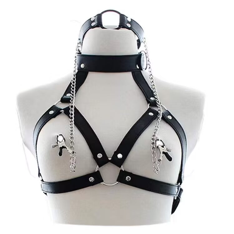 Front view of black PU leather body harness styled with detachable O-ring choker and chain nipple clamps on a mannequin.