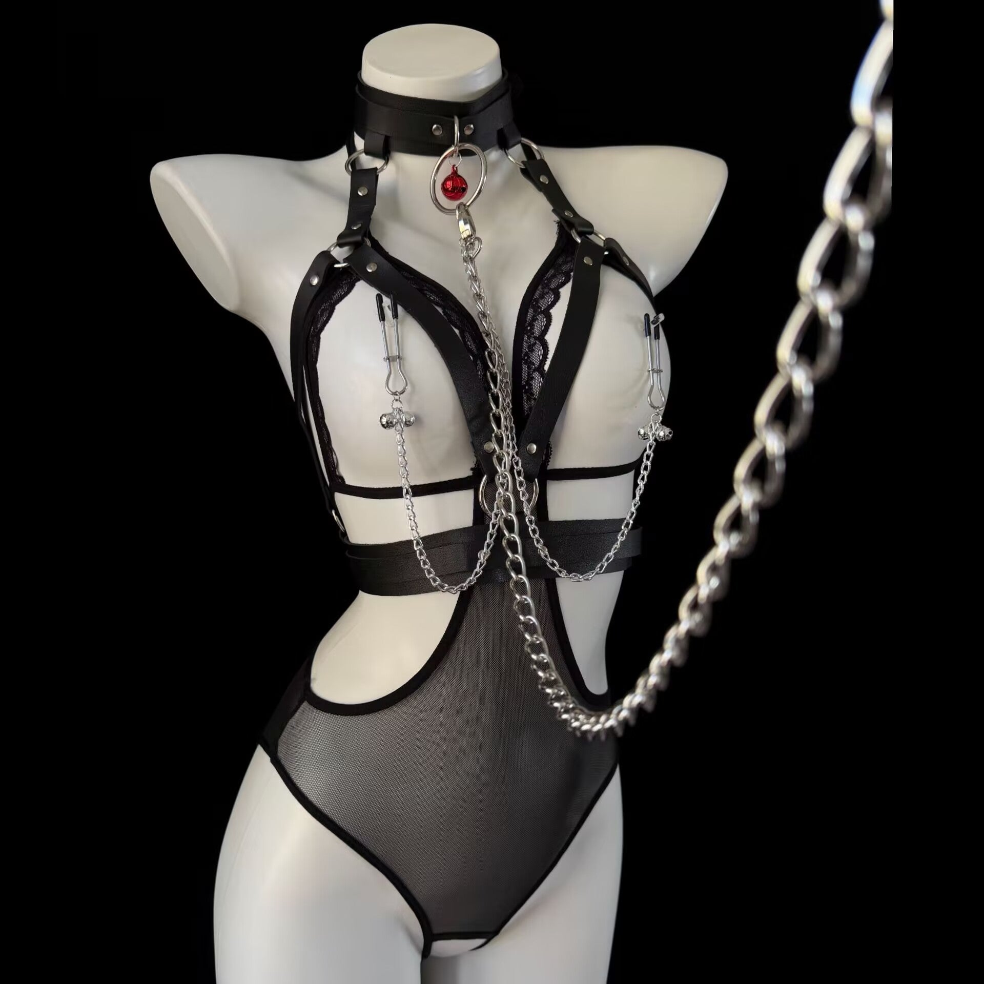 Leather body harness set featuring a red bell collar with attached chain leash on display