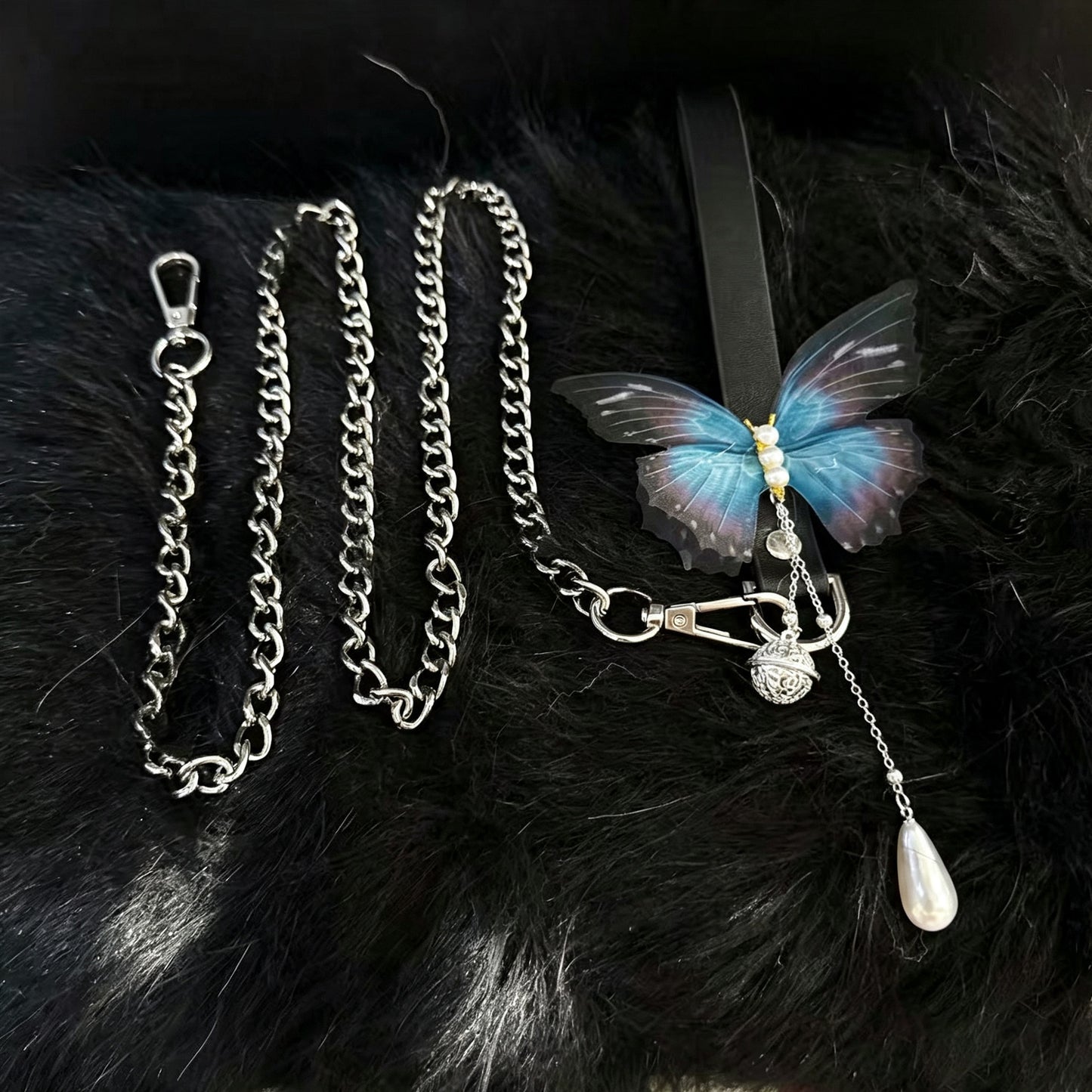 Black leather butterfly choker collar paired with heavy-duty metal tether restraint chain with lobster clasp.