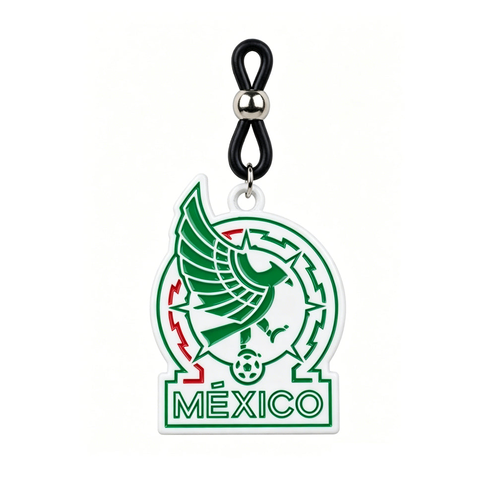 Close-up of a non-piercing nipple clamp from the Mexico soccer fans pair, featuring an adjustable black silicone loop with a metallic bead and green Mexico national football team logo charm on a white background.