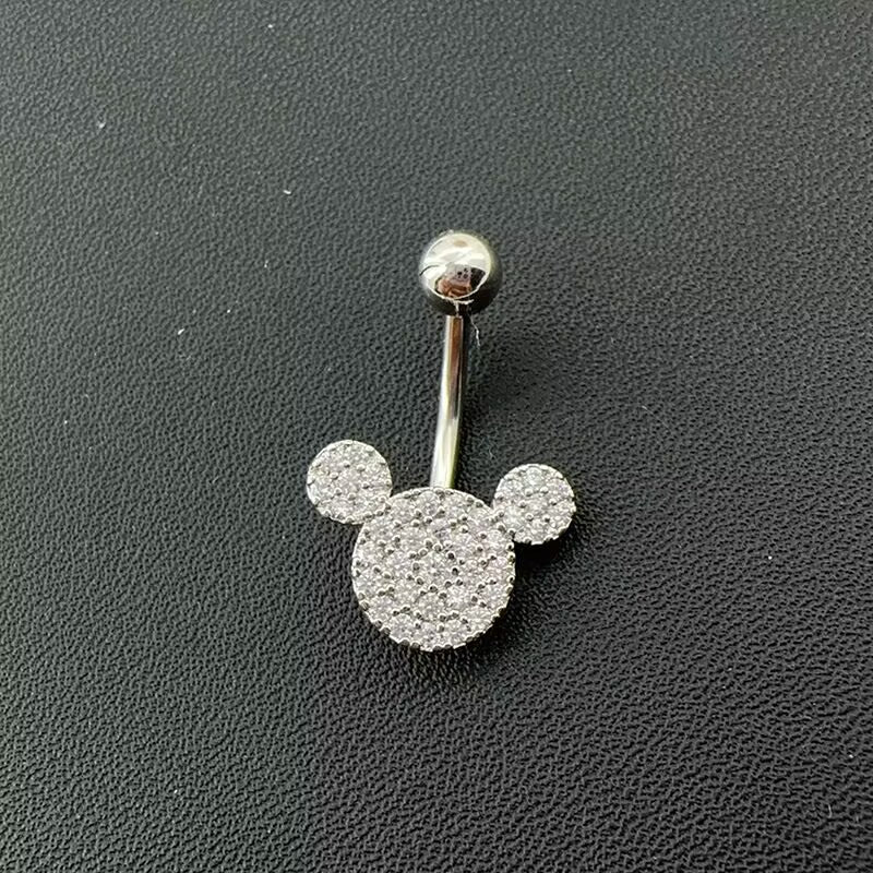 Product detail shot of mouse ear CZ pave belly ring featuring smooth top ball and standard 14G curved barbell body jewelry.