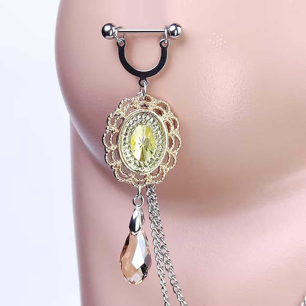 Detailed close-up of a stainless steel nipple ring barbell connected to a dangling yellow crystal charm and chain links.