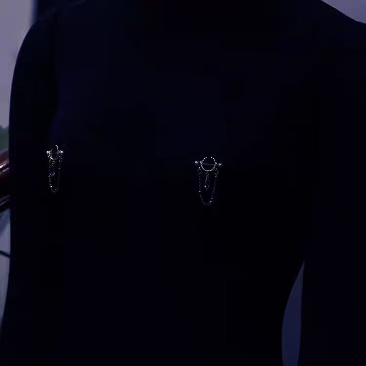 Front view fit check showing a pair of crystal dangle nipple shield barbells worn on mannequin.
