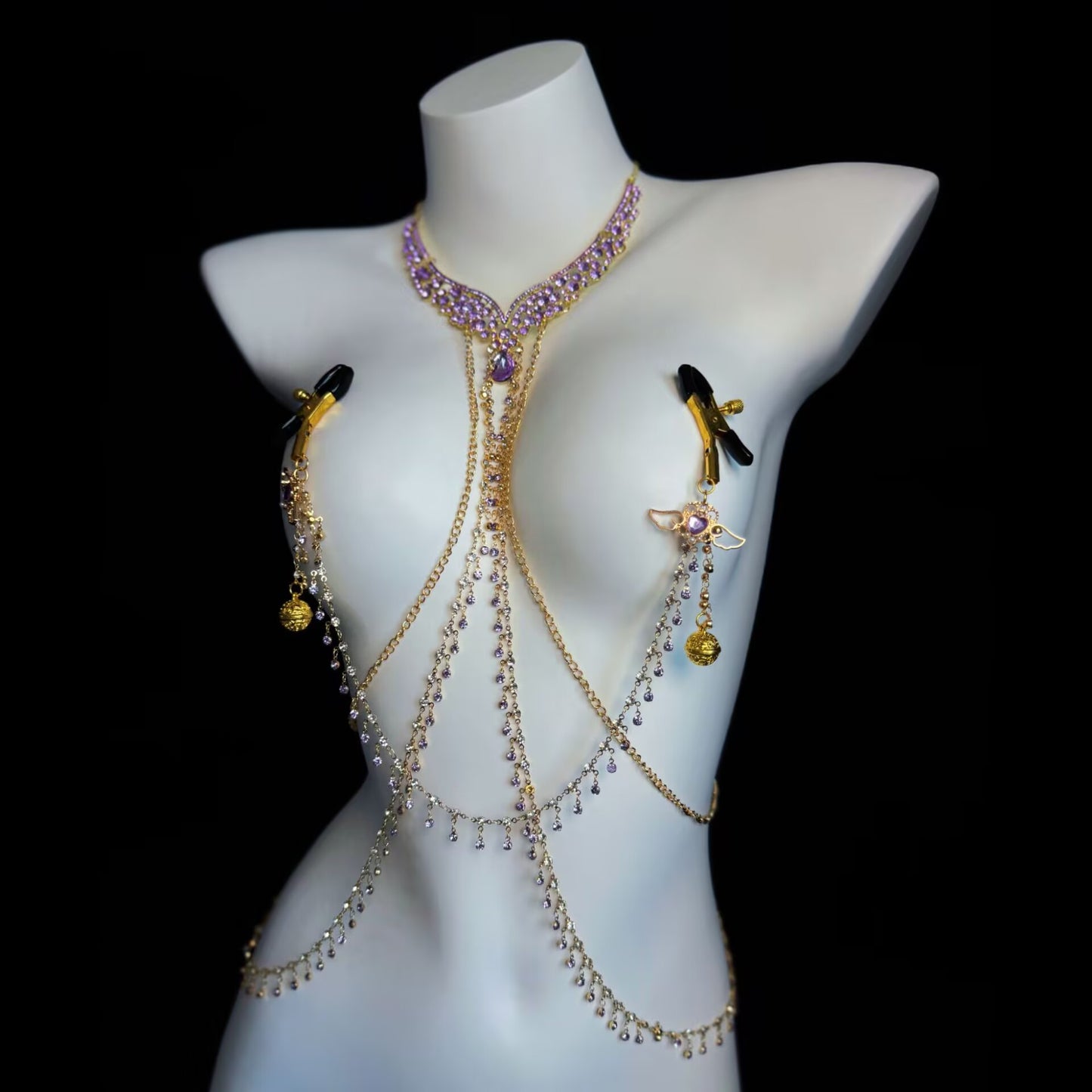 Purple crystal body chain harness configured with rubber-tipped non-pierced nipple clamps on a female torso mannequin.