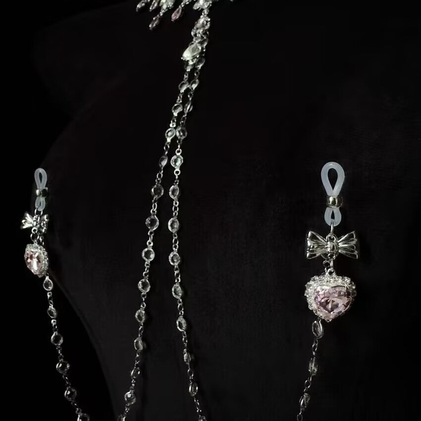 Non pierced nipple rings with adjustable silicone loops and dangling pink heart crystal pendants.