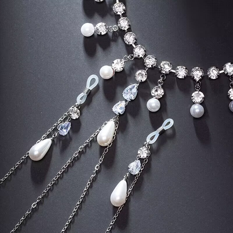 Close up view of non-pierced silicone loops, crystal rhinestones, and teardrop pearl pendants on body chain.