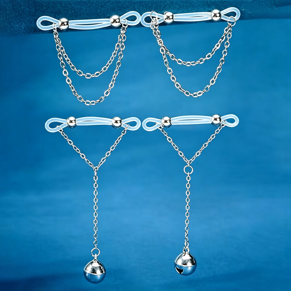 Two pairs of non-piercing clear silicone nipple clamps on a blue background, including one pair with silver double chains and one pair with silver bell pendant chains.