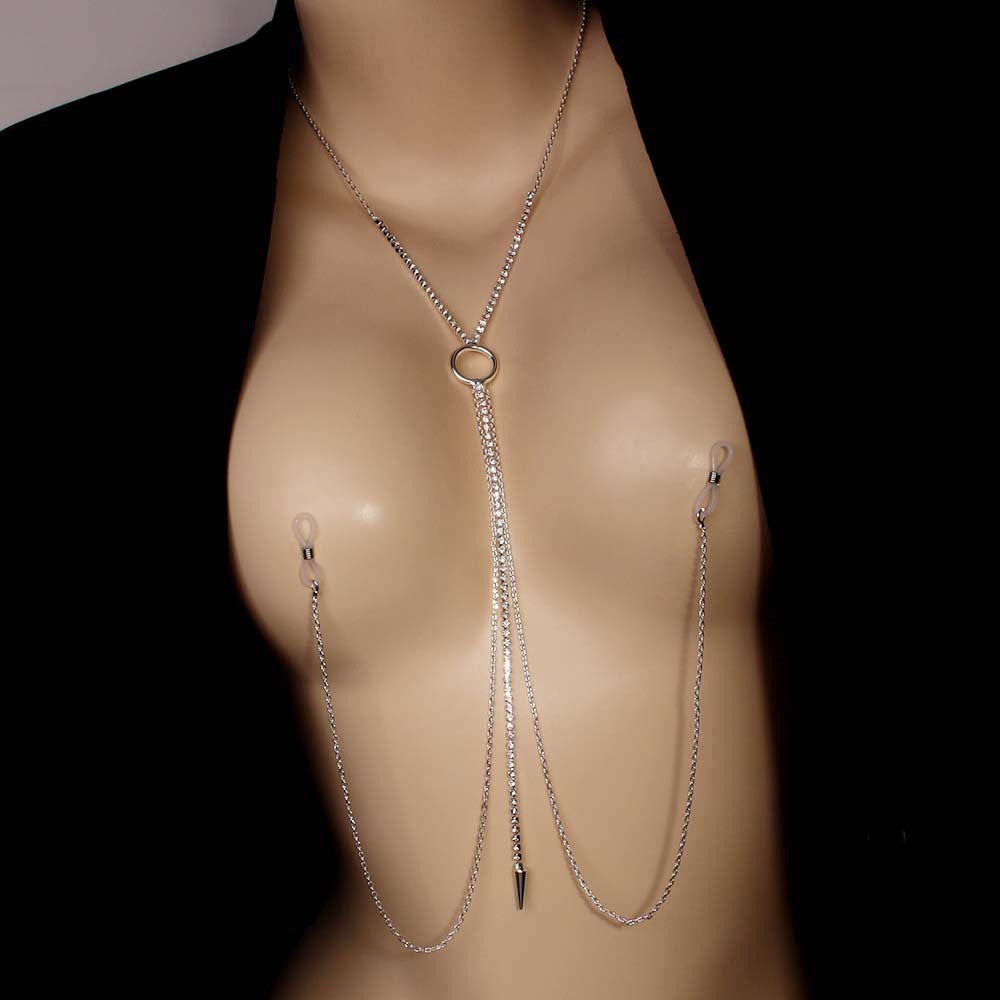 Silver non-piercing nipple rings with rhinestone body chain necklace worn on a mannequin under a black blazer jacket.
