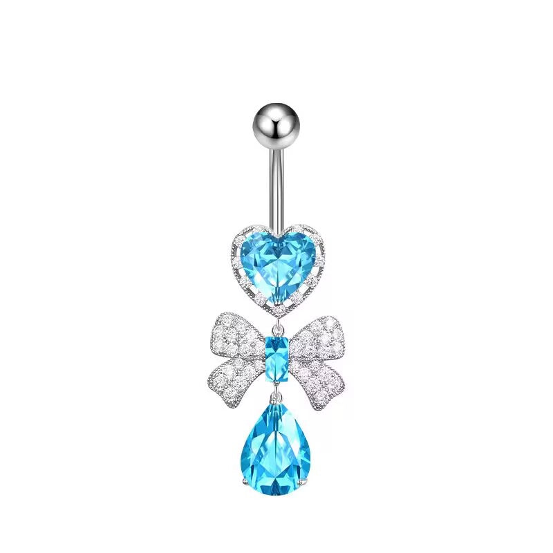 Ocean blue crystal heart and paved bowknot dangle belly button ring on a white background.