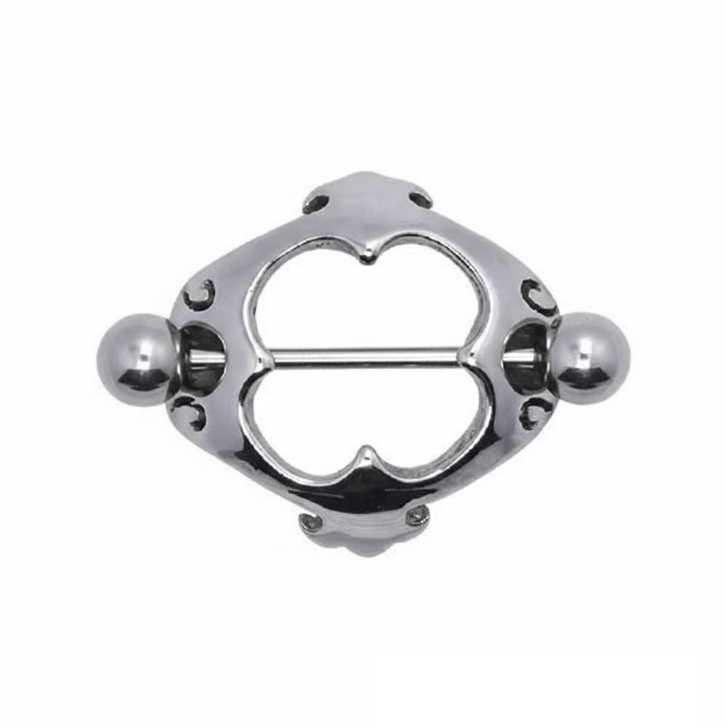 Front view of an ornate heart-shaped nipple shield with symmetrical filigree patterns.