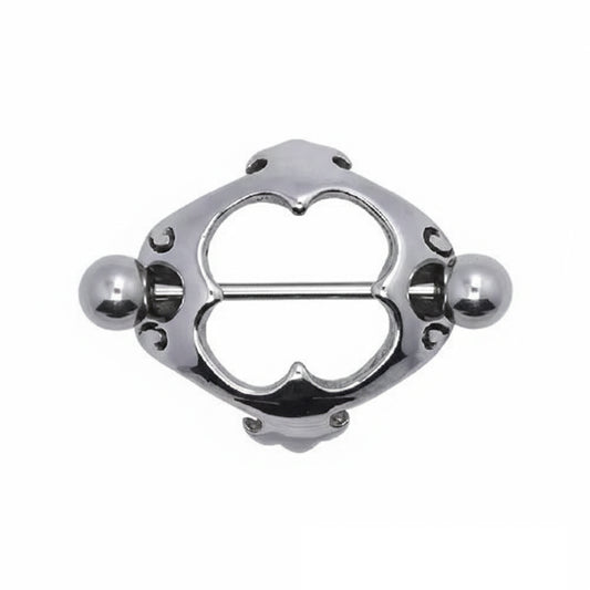 Front view of an ornate heart-shaped nipple shield with symmetrical filigree patterns.