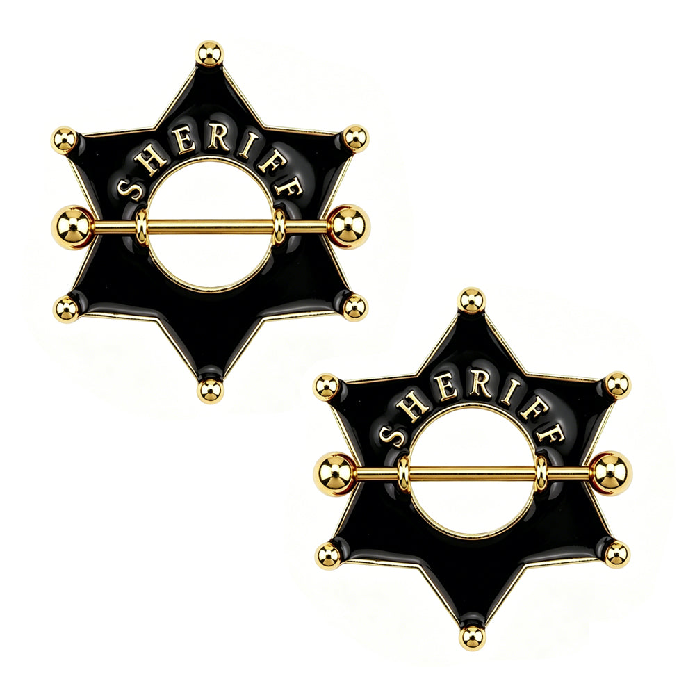 A pair of black sheriff badge nipple shield piercings on white background