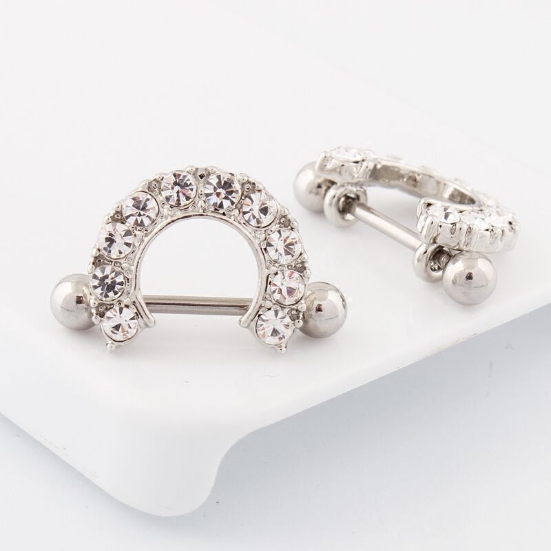 A pair of elegant crystal nipple shields displayed together, highlighting the shimmering U-shaped decorative frame.