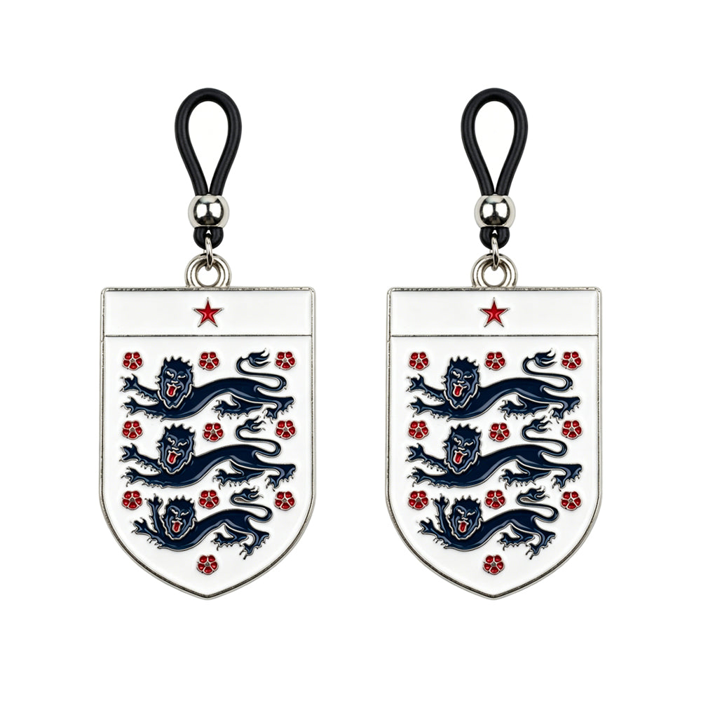 A matching pair of adjustable non-piercing nipple loops with English football heritage shield charms on a pure white background for alternative body jewelry styling.