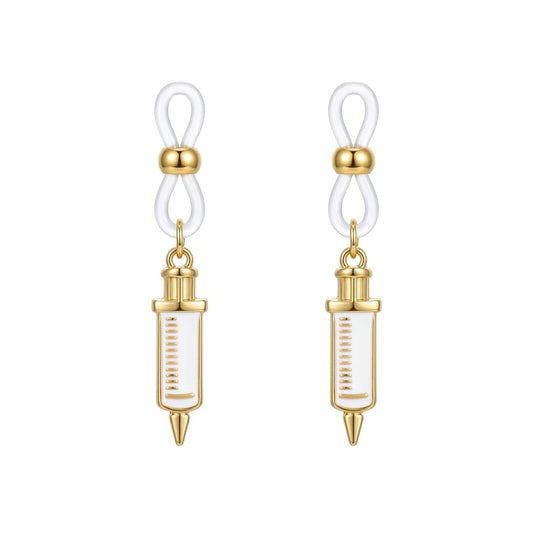 One matching pair of non-piercing fake nipple rings with white and gold medical syringe charms and secure clear silicone loops for adult bedroom roleplay.