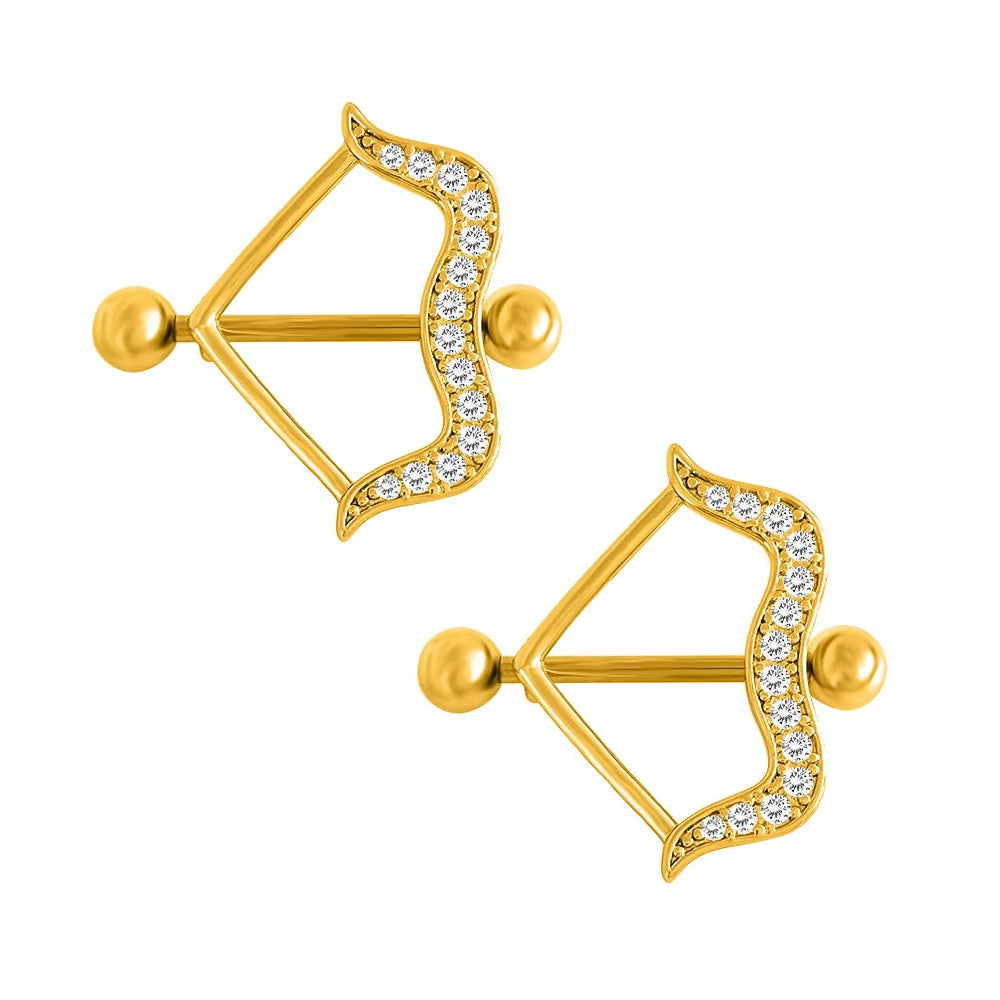 Pair setup of gold cupid core bow nipple piercing shields with clear glittering pavé rhinestones, perfect for unique western aesthetic jewelry trends.