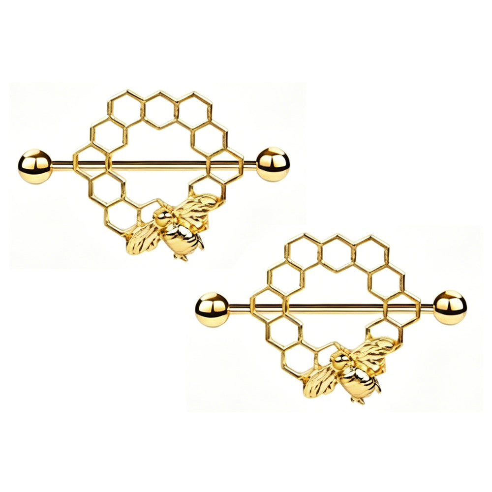 A matching pair of golden bee and honeycomb design nipple shield rings on a white background.
