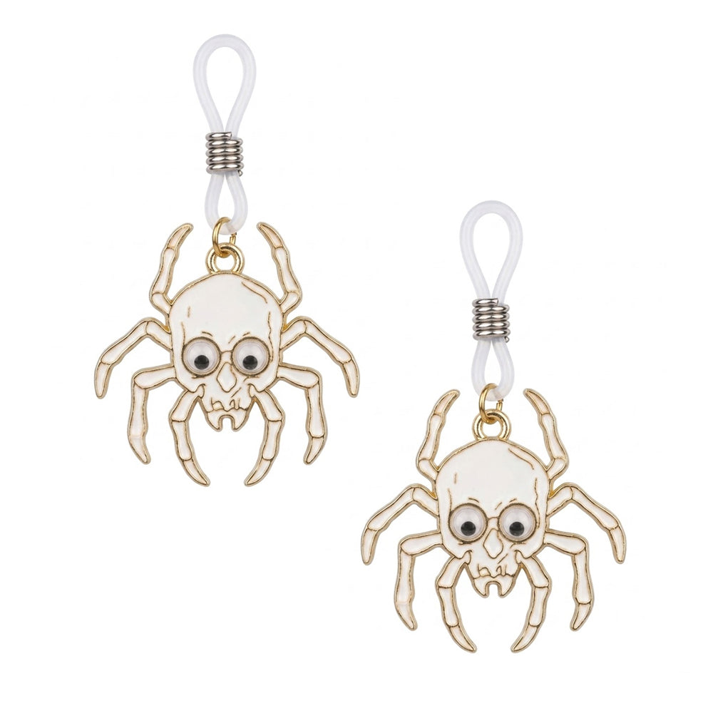 A pair of alternative gothic skull spider non-piercing body jewelry loops with white enamel detail and playful googly eyes, displayed on a clean white background.