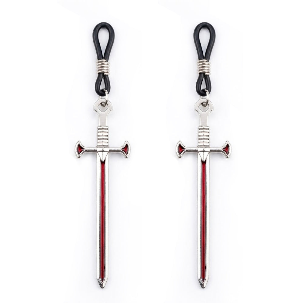 Two silver-toned medieval sword pendants with red line details designed as non-piercing nipple jewelry for an edgy aesthetic.