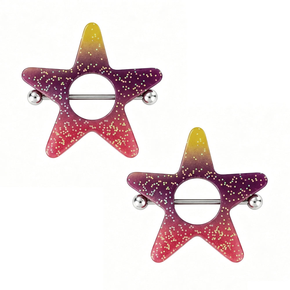 A pair of ombre sunset star nipple rings sold as a set, with colorful glitter shields and biocompatible 14 gauge professional piercing barbells.