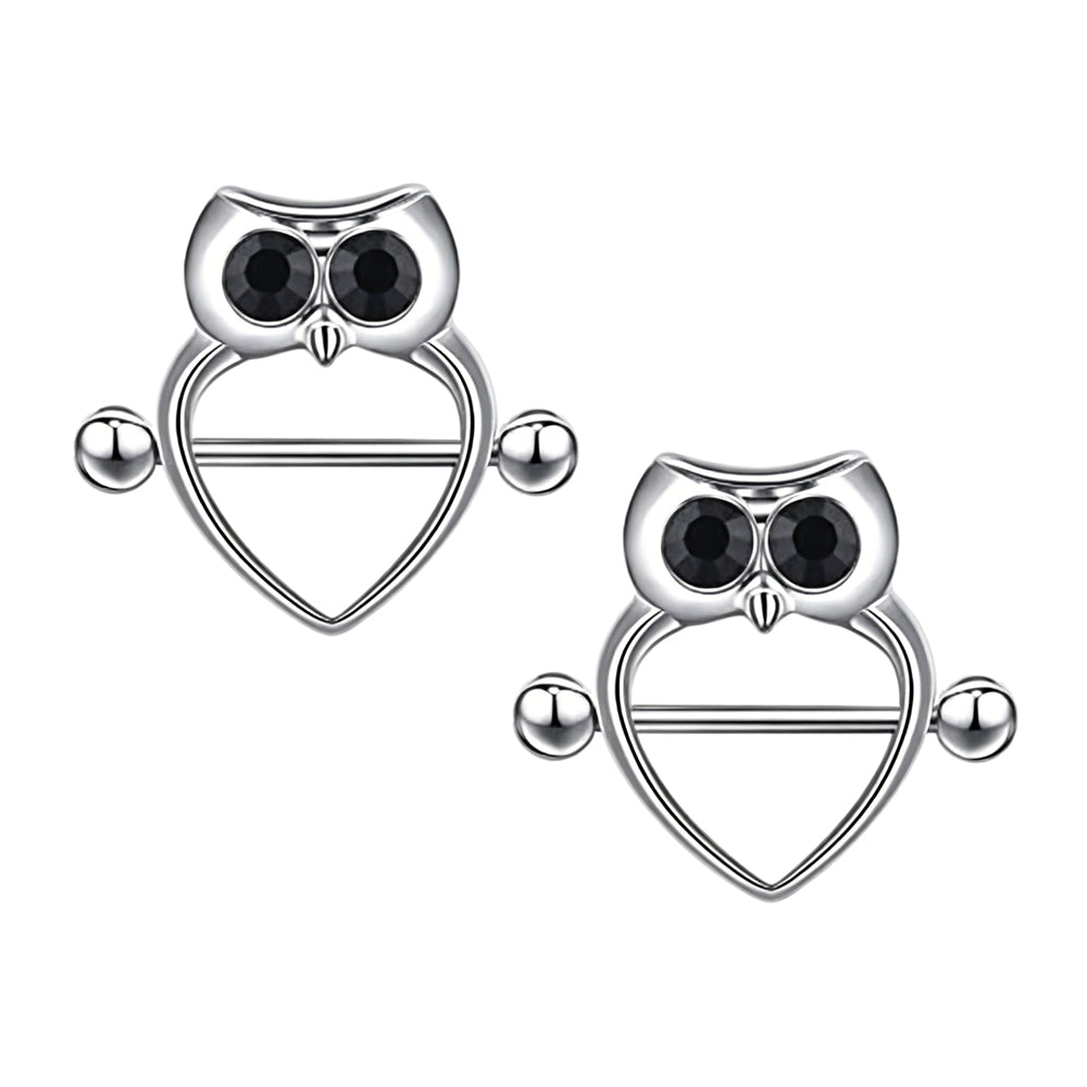 A matching pair of two silver-colored owl heart nipple shield rings with black crystal eyes, sold as a set of 2 for alternative body body piercing styling.
