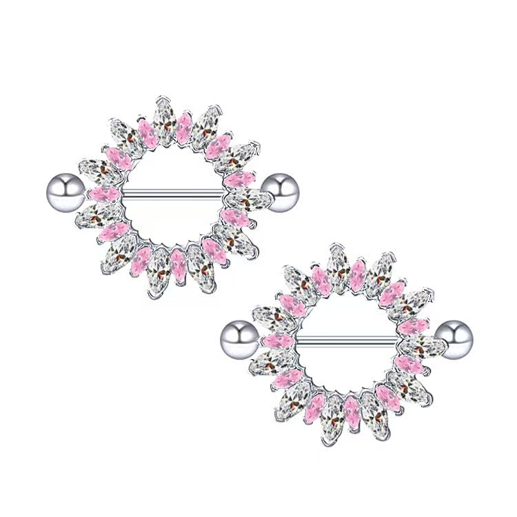 A pair of identical sunflower nipple shield rings with pink and clear gemstones on a clean white background for alternative body jewelry styling.