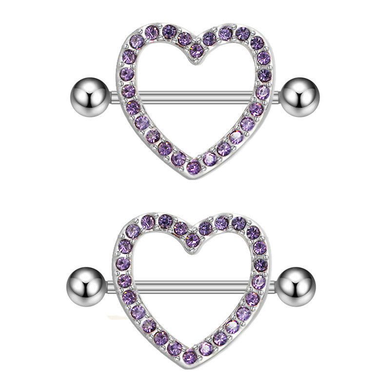 A matching pair of silver-tone heart nipple shields featuring sparkling purple crystal accents for a symmetrical look.