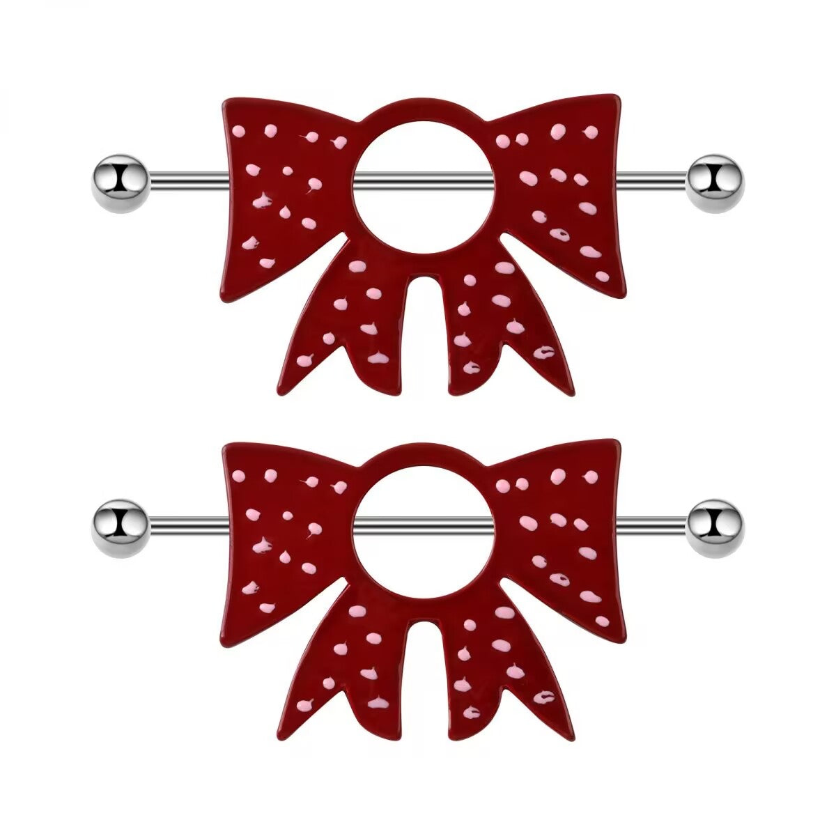 A pair of alternative coquette style deep red and pink polka dot bowknot nipple shield jewelry displayed vertically.