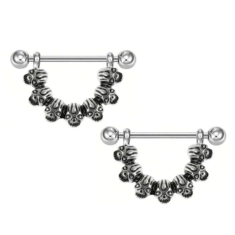A pair of vintage style skull nipple barbells showing the symmetrical design.