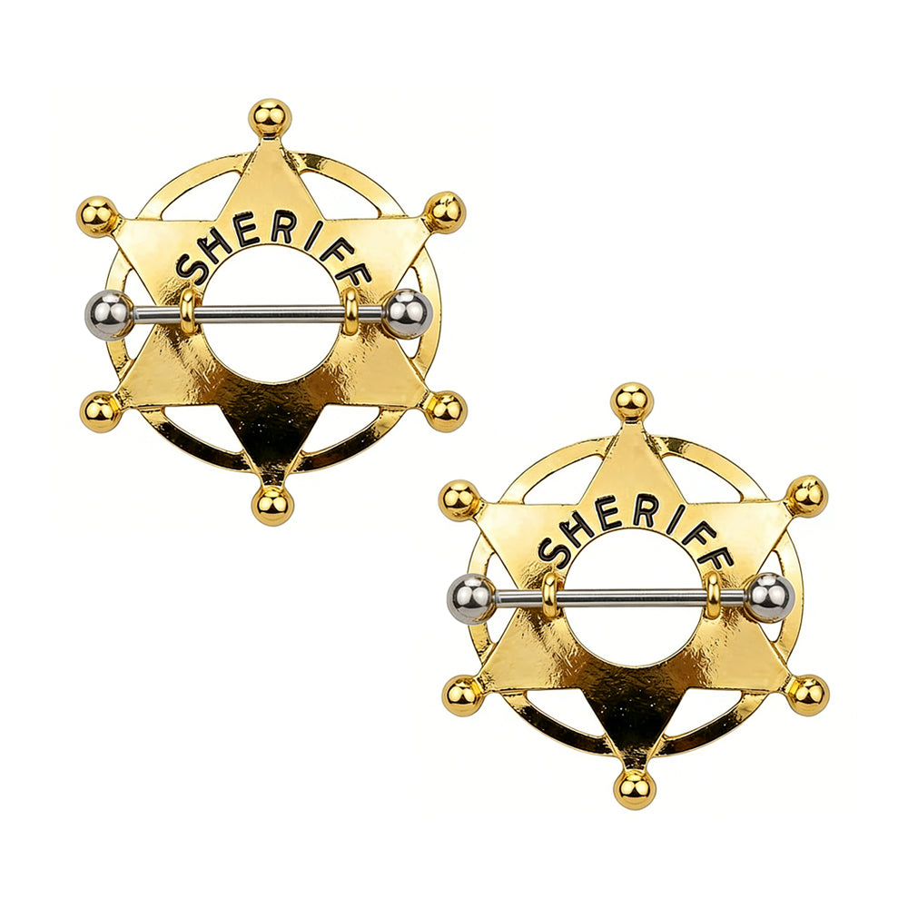 A pair of gold-toned western star sheriff nipple shields on white background.